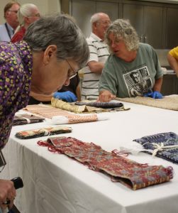 Members of the weaver’s group, Colloquy, viewing the collection in October 2013