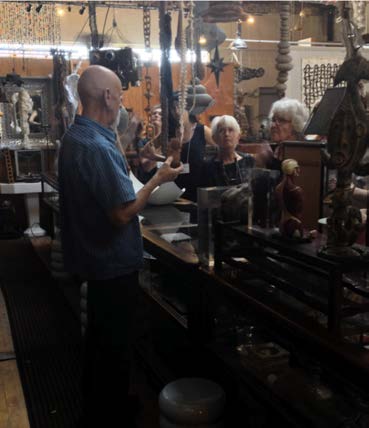 Graham explaining the history of some of his found objects to TSA members during studio tour