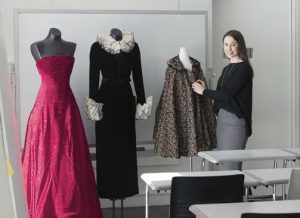 Curator and teacher Marcella Milio in her classroom with garments from the collection on display.