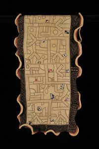 Kuba Textiles: Geometry in Form, Space, and Time: Woman’s Overskirt (ncák minen'ishushuna), Kuba peoples, Bushoong group, Nsheng, Democratic Republic of the Congo, Late 19th - early 20th century, Raffia, cotton cloth, wool, appliqué, embroidery, with cut-pile (borders), Collection Musée Royal de l’Afrique Centrale, Tervuren, EO.0.0.27401, Gift of Nyim Lukengo’s wife to Marcel Van den Abeele, before 1924. Photo credit/copyright: Collection MRAC Tervuren; photo J.-M. Vandyck, MRAC Tervuren ©.