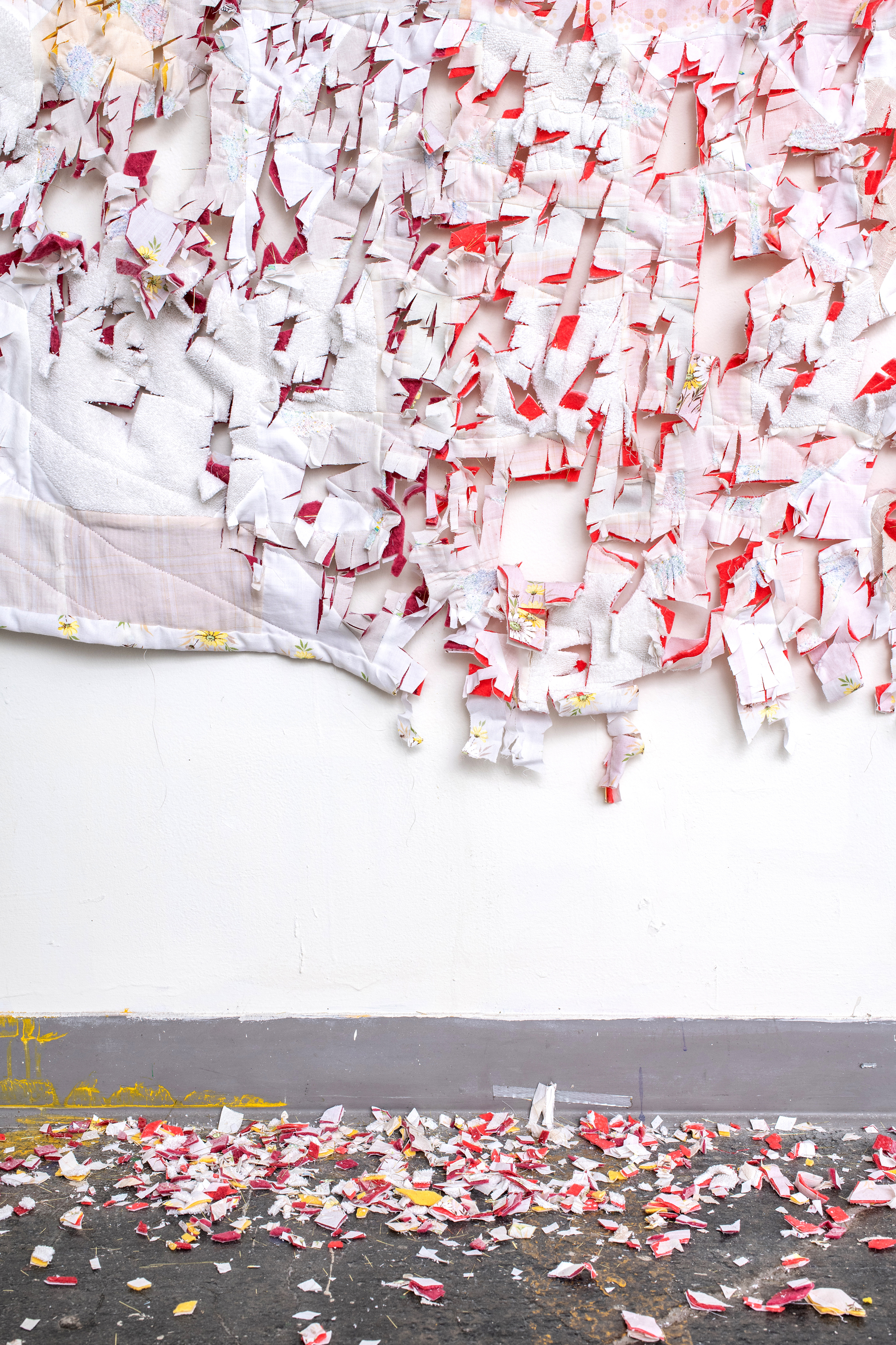 Marie Fornaro. It Is Bread We Fight For, But We Fight for Roses, Too (detail) (2018) bleached clothing, towels and bedsheets, hand-dyed cotton batting, thread, tinsel.