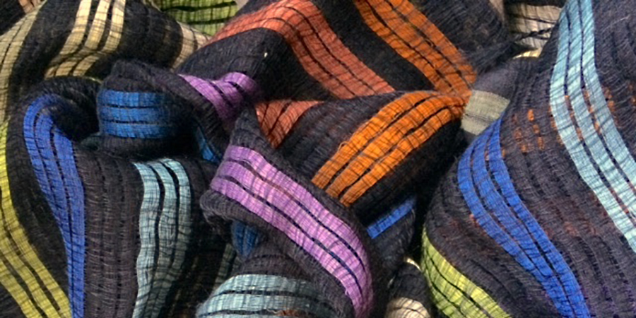 Close up photo of a handwoven scarf with colorful stripes