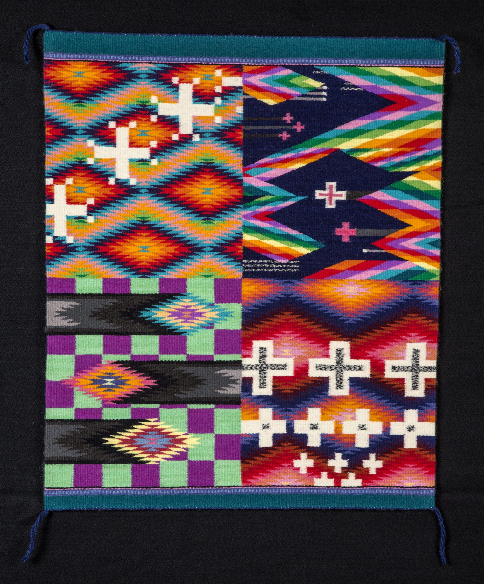 Vibrant tapestry is broken up into quadrants with traditional Navajo diamond shapes topped with contemporary plus signs.