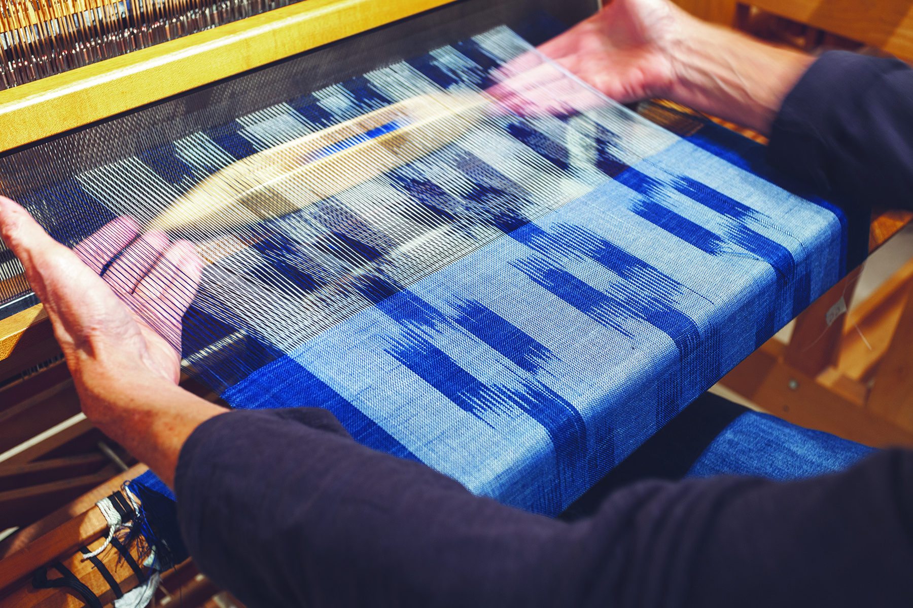 Warp ikat Checkerboard Stole in weaving process at the loom.