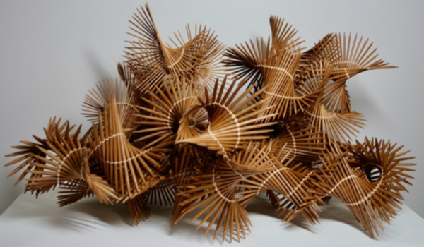 bamboo knitting needles twined together in a twirly pile