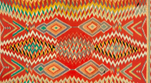 A dazzling optical design of repeating diamond patterns in red, gold, blue, black, and white